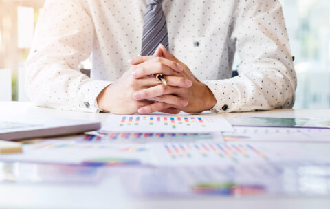 Working process startup. Businessman working at the wood table w