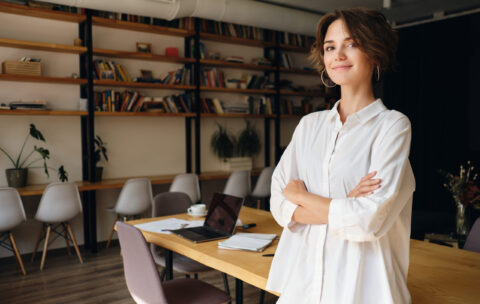 Young attractive woman in white shirt dreamily looking in camera