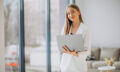 Young business woman in white suit working on a computer