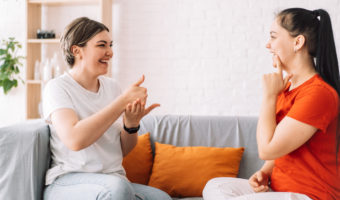 Teacher teaches girl sign language