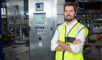 Portrait of confident male worker standing in factory
