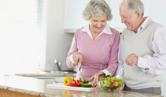 Senior couple preparing salad together. Image shot 2009. Exact date unknown.