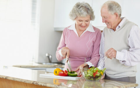 Senior couple preparing salad together. Image shot 2009. Exact date unknown.
