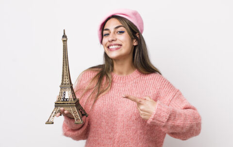 smiling cheerfully, feeling happy and pointing to the side