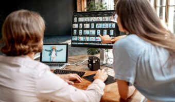 Couple of photographers working on computers in the studio