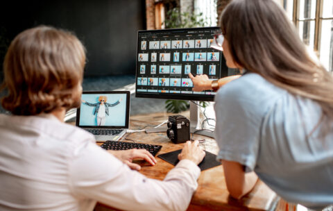 Couple of photographers working on computers in the studio