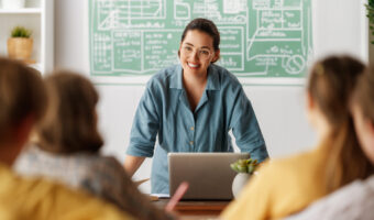 Happy kids and teacher at school