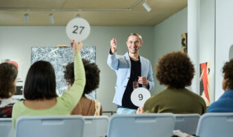 Pointing at one of female auctioneers