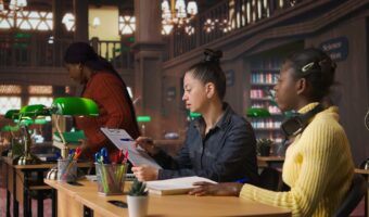 Portrait of cute young schoolgirl entering the library to study in peace