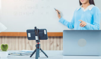 Teacher remotely using camera to stream lesson working call vide