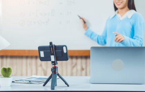 Teacher remotely using camera to stream lesson working call vide