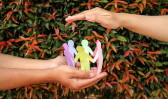 arrangement-paper-human-figures-making-circle-protective-hands-gesture