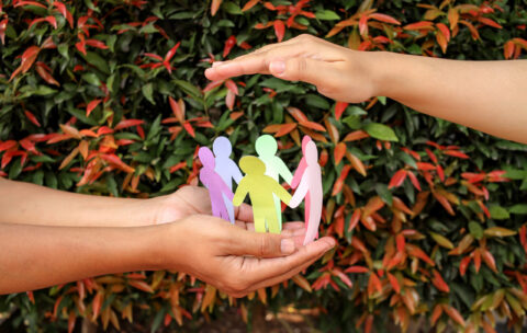 arrangement-paper-human-figures-making-circle-protective-hands-gesture