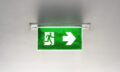 Green emergency exit sign on the ceiling