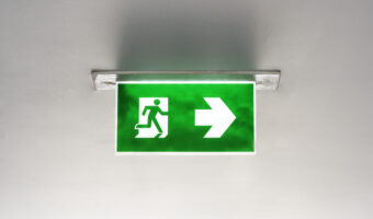 Green emergency exit sign on the ceiling