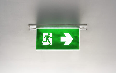 Green emergency exit sign on the ceiling