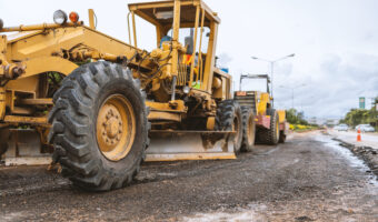 closeup excavators removing stone in the construction works of a