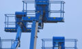low-angle-view-crane-against-clear-blue-sky