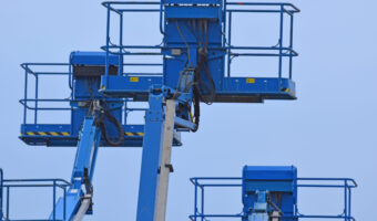 low-angle-view-crane-against-clear-blue-sky