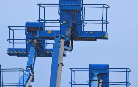 low-angle-view-crane-against-clear-blue-sky