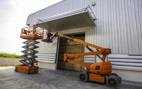 Workers working on the construction site of the new factory indu