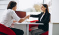 Man talking with female sales person in a car show room