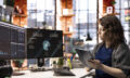 Woman at agency office using financial application UI on PC screen