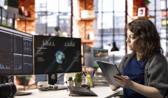 Woman at agency office using financial application UI on PC screen