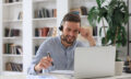 Smiling young business man having video call in office.