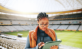 woman-coach-typing-with-tablet-stadium-sports-event-competition-review-tactics-african-person-tech-click-with-application-stats-decision-strategy-game-kenya