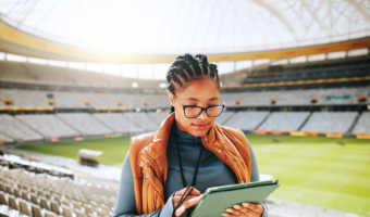 woman-coach-typing-with-tablet-stadium-sports-event-competition-review-tactics-african-person-tech-click-with-application-stats-decision-strategy-game-kenya