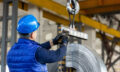 worker uses control joystick in factory