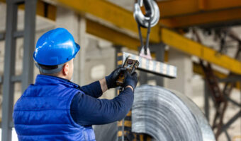 worker uses control joystick in factory
