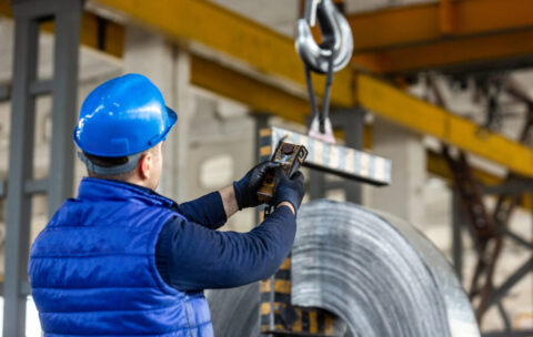 worker uses control joystick in factory